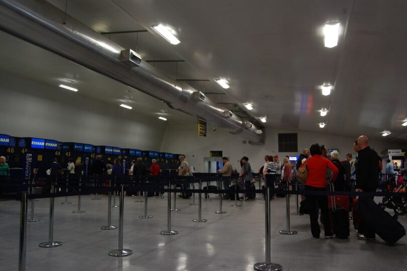 Passengers moving through an airport terminal