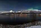 Bright aurora lights dancing across a dark night sky during a solar storm.