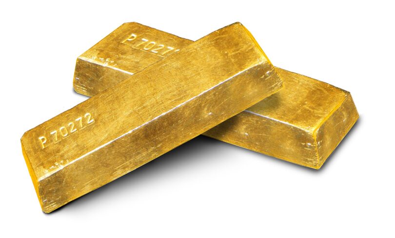 Stacked gold bars in a secure vault