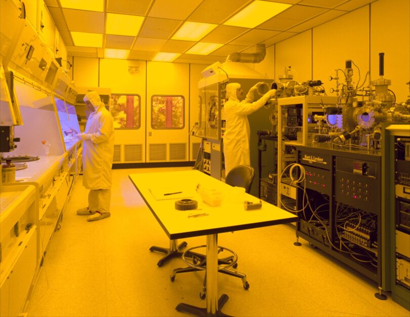 Semiconductor cleanroom engineers working on silicon wafer production lines